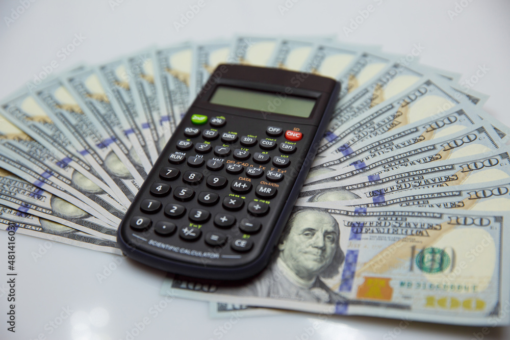 calculator with money american dollars. Business background calculator with money american dollars. Business background