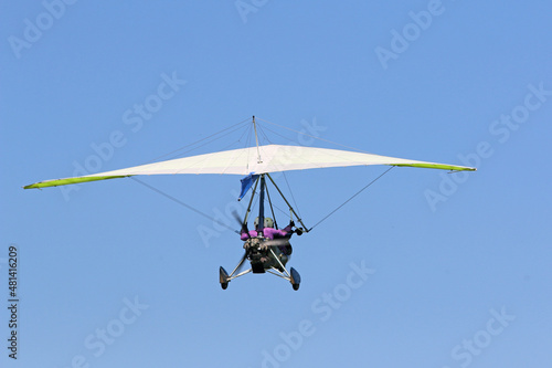 Valokuva Ultralight airplane flying in a blue sky