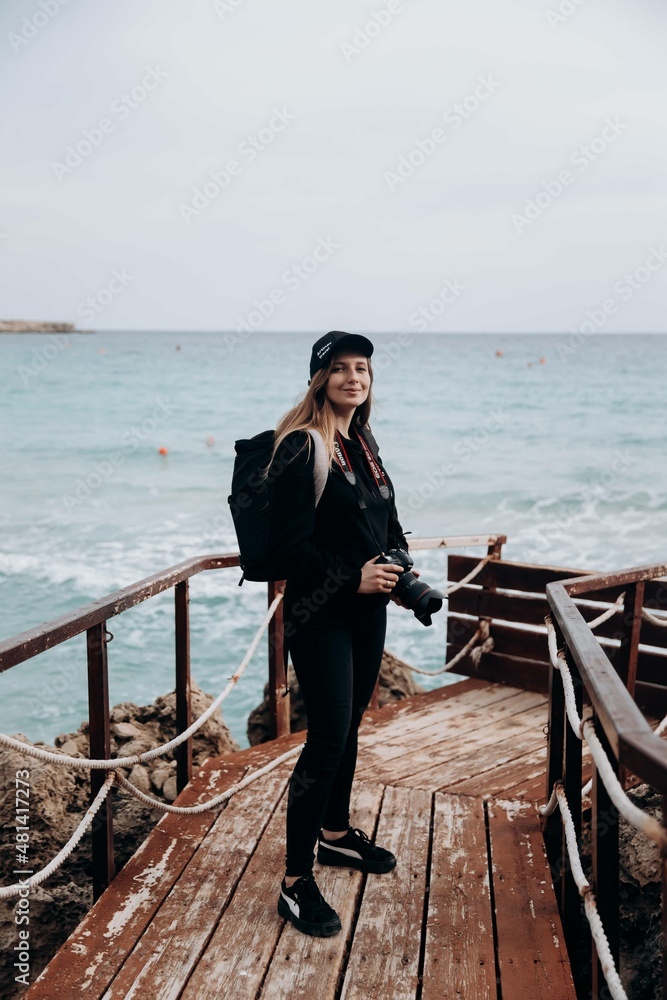 woman photographer on the pier of cyprus 