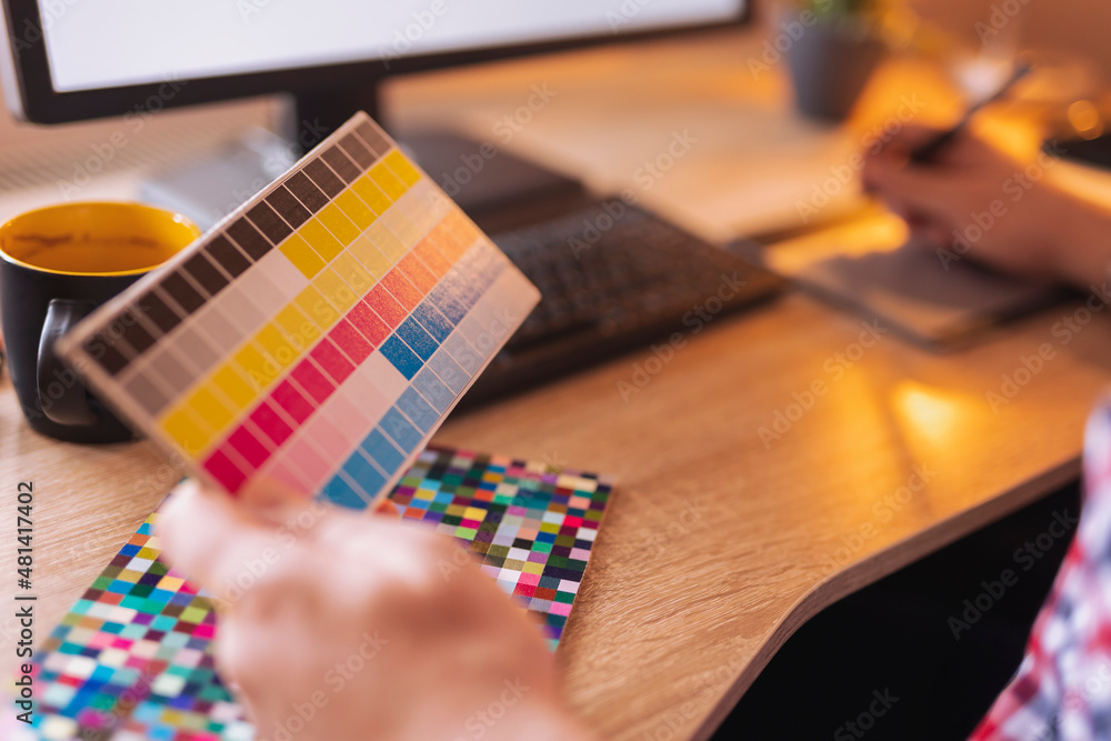 Fototapeta premium Designer choosing color from color pallete while working
