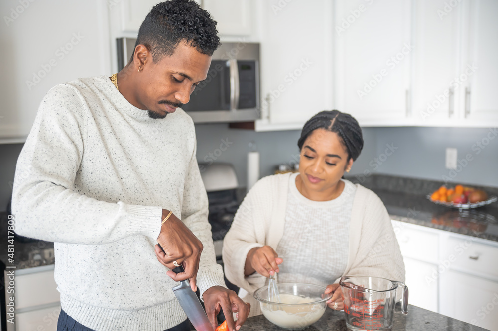 Couple preparing food in kitchen Couple preparing food in kitchen
