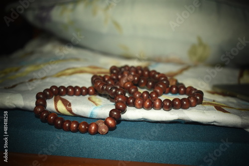 a string of beads used in praying and meditating 