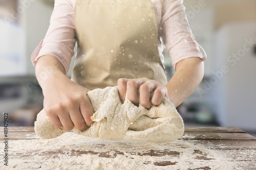 Beautiful and strong hands knead the dough make bread, pasta or pizza. photo