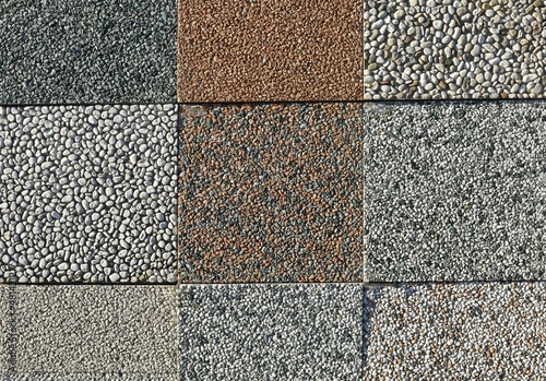 Samples of aggregate concrete patio tiles with pebbles of different colors.