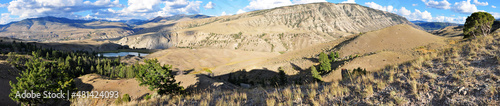 panoramic view of a mountain landscape in yellowstone national park, showing a slightly cloudy sky. 
