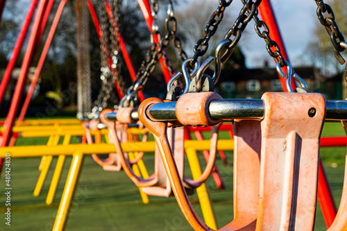  zoom in on the swings in the playground next to a school in Heywood
