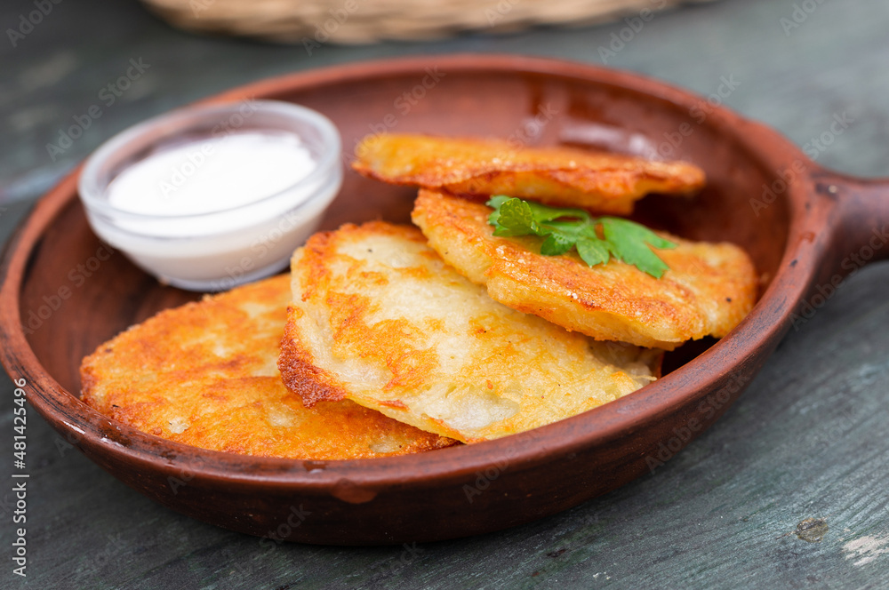 Fried grated potato pancakes with sour cream Fried grated potato pancakes with sour cream