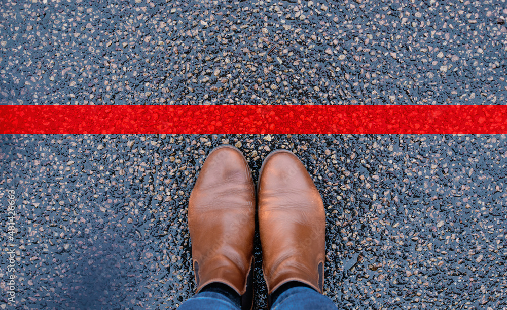 Red line on the road, someone is standing in front of the stop, covid ...