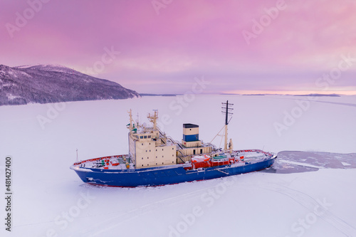 Icebreaking vessel in Arctic with background of sunset