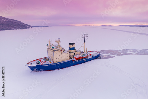 Icebreaking vessel in Arctic with background of sunset