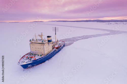 Icebreaking vessel in Arctic with background of sunset