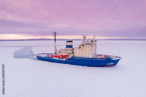 Icebreaking vessel in Arctic with background of sunset
