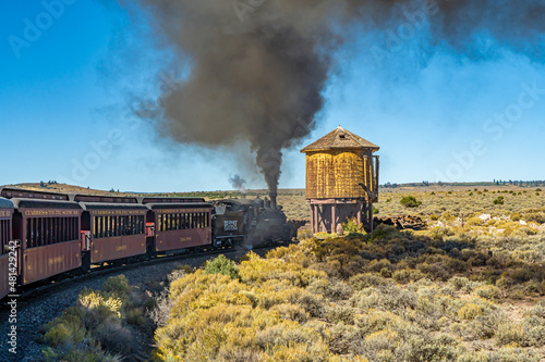 Antonio, Colorado - 9-21-2021: A steam engine locomotive and passenger cars on the Cumbris & Toltec scenic railroad near Antonio colorado, also water tower, photo