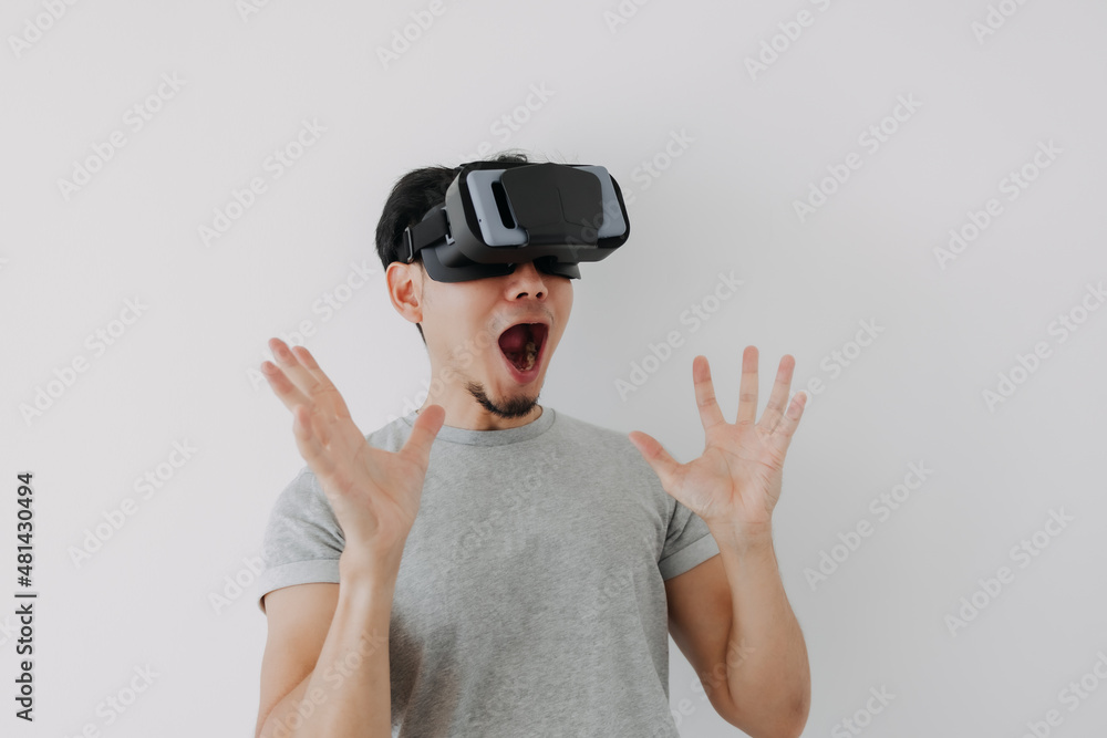 Wow surprised face of Asian man wears virtual glasses for metaverse technology. Wow surprised face of Asian man wears virtual glasses for metaverse technology.