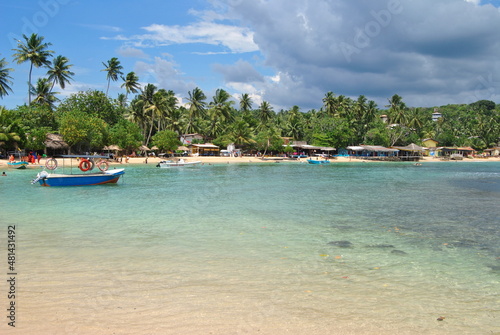 Sri Lanka island, Beach, palm trees, lagoon. Sea, ocean. Ceylon, India. A boat in the sea.