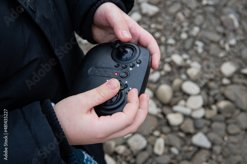 remote control for a radio-controlled model in the hands of a child