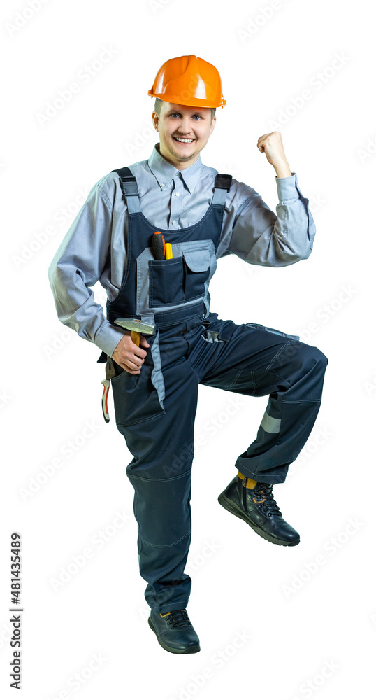 Worker, engineer, builder, locksmith rejoices at a job well done. a man rejoices with a gesture, raises his knee up and pulls his elbow to his knee. isolated. full height. Worker, engineer, builder, locksmith rejoices at a job well done. a man rejoices with a gesture, raises his knee up and pulls his elbow to his knee. isolated. full height.