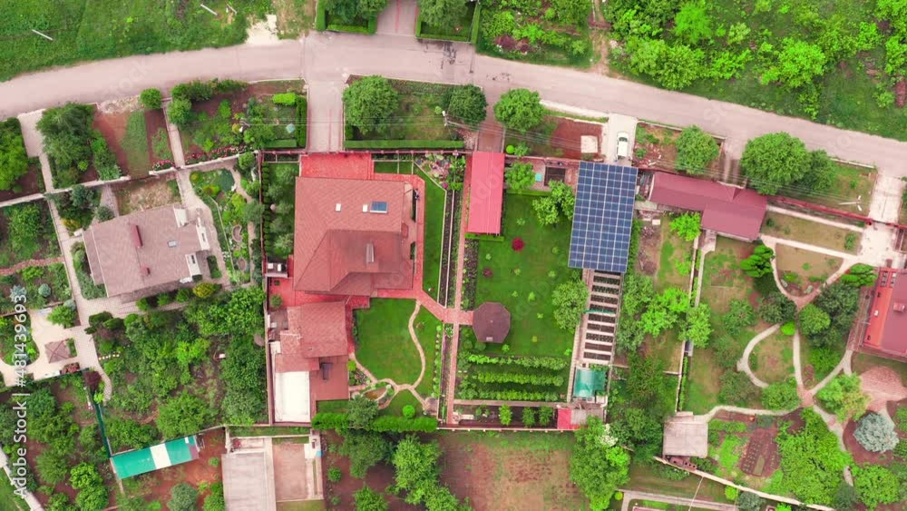 Modern cottage house with Solar Panels among green lawns and gardens ...
