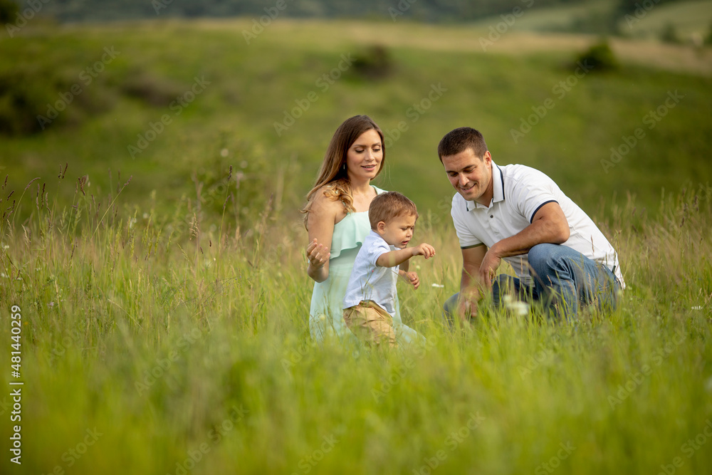 Young family having fun outdoors in the field