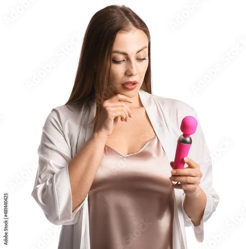 Thoughtful young woman with vibrator on white background photo