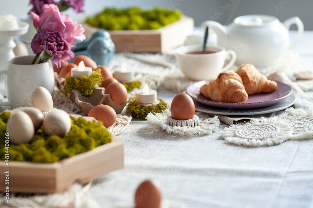 Cozy elegant festive table decor for Easter in a light tone. handmade macrame products, eggs. Cozy elegant festive table decor for Easter in a light tone. handmade macrame products, eggs.