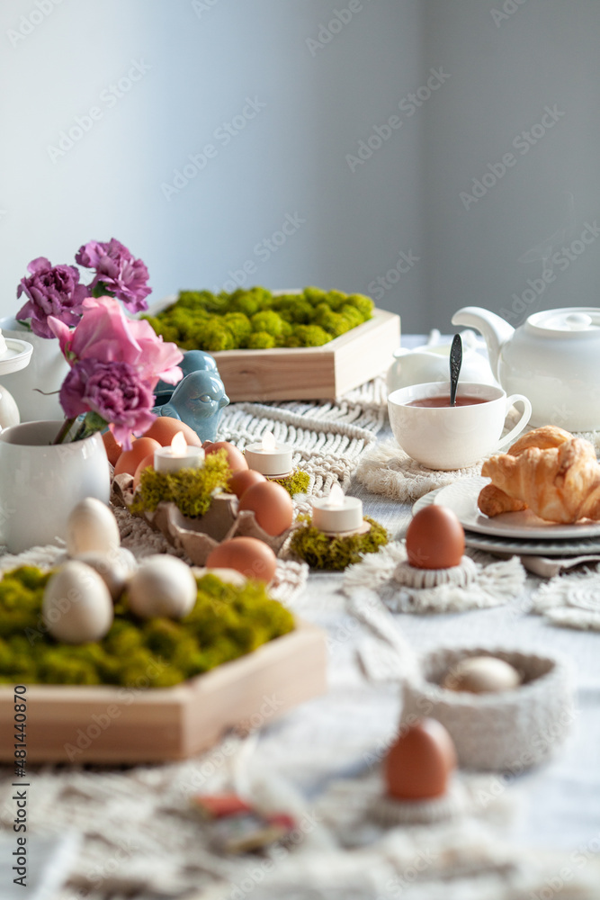 Cozy elegant festive table decor for Easter in a light tone. handmade macrame products, eggs. Cozy elegant festive table decor for Easter in a light tone. handmade macrame products, eggs.