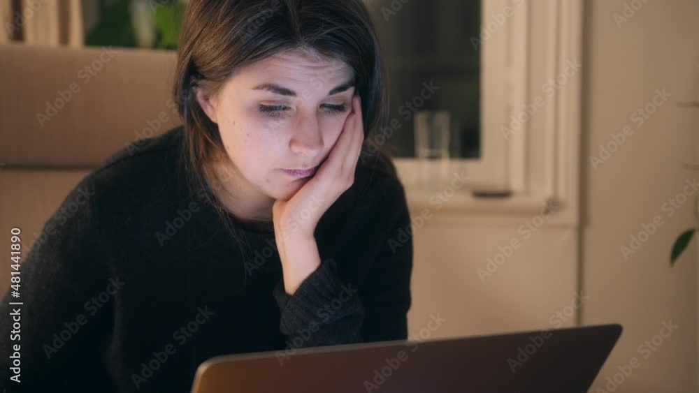 Young Female react with excitement while internet shopping for Clothes On Laptop, focused web browsing or learning education Young Female react with excitement while internet shopping for Clothes On Laptop, focused web browsing or learning education