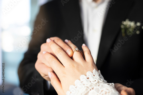 Photos Couple wearing wedding ring at wedding day of them.