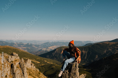 woman sitting at the top of the mountain