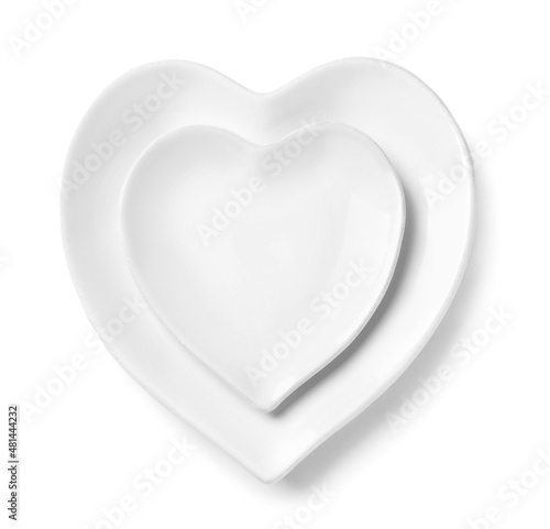 Beautiful heart-shaped plates on white background