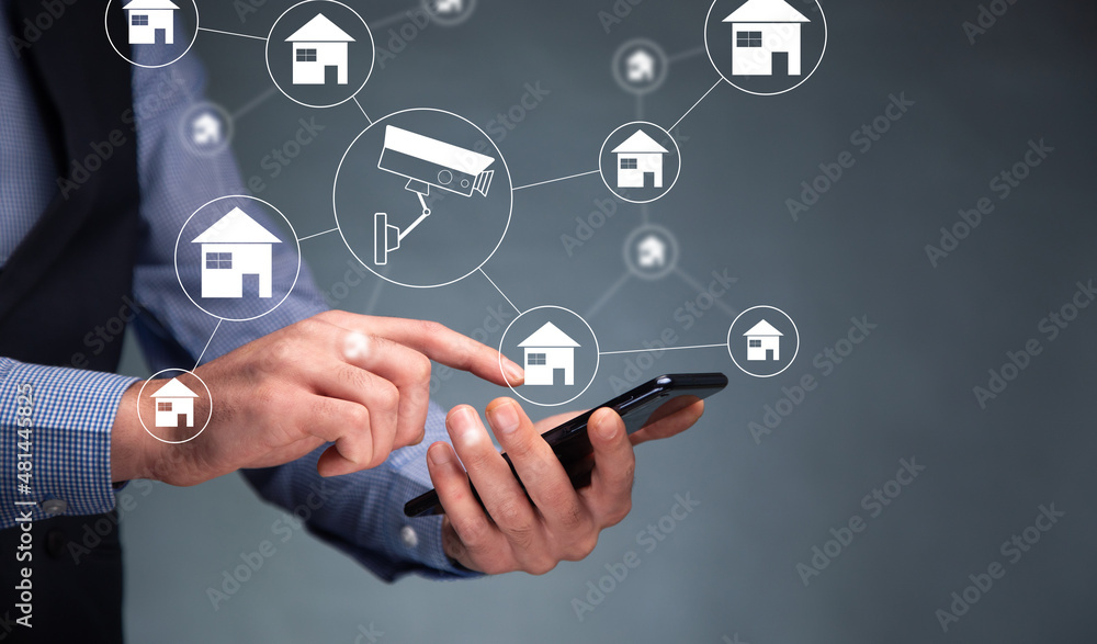 Businessman holding phone with Smart home interface Businessman holding phone with Smart home interface