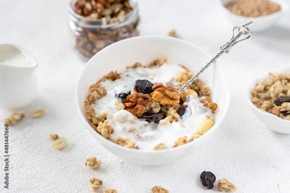granola,muesli with nuts, raisins and yogurt on a light background ,selective focus granola,muesli with nuts, raisins and yogurt on a light background ,selective focus