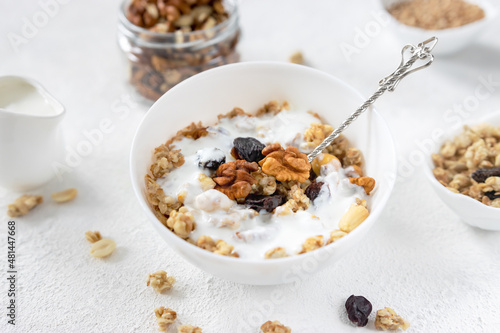 granola,muesli with nuts, raisins and yogurt on a light background ,selective focus