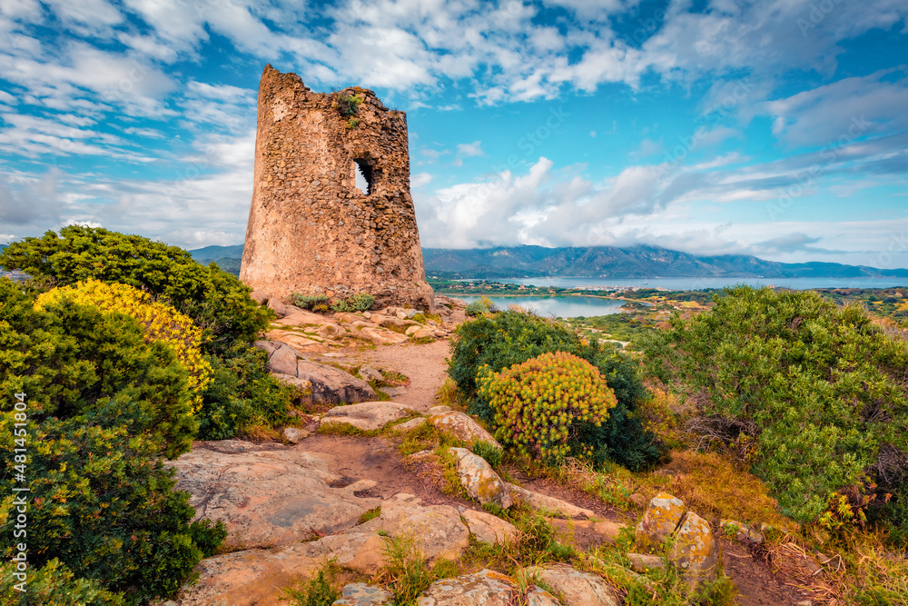 Beautiful summer scenery. Old Torre di Porto Giunco tower on Carbonara cape. Picturesque morning view of Sardinia island, Italy, Europe. Aerial Mediterranean seascape.