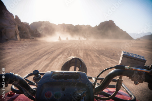 Point-of-view shot from person riding a quad bike in the mountains. photo