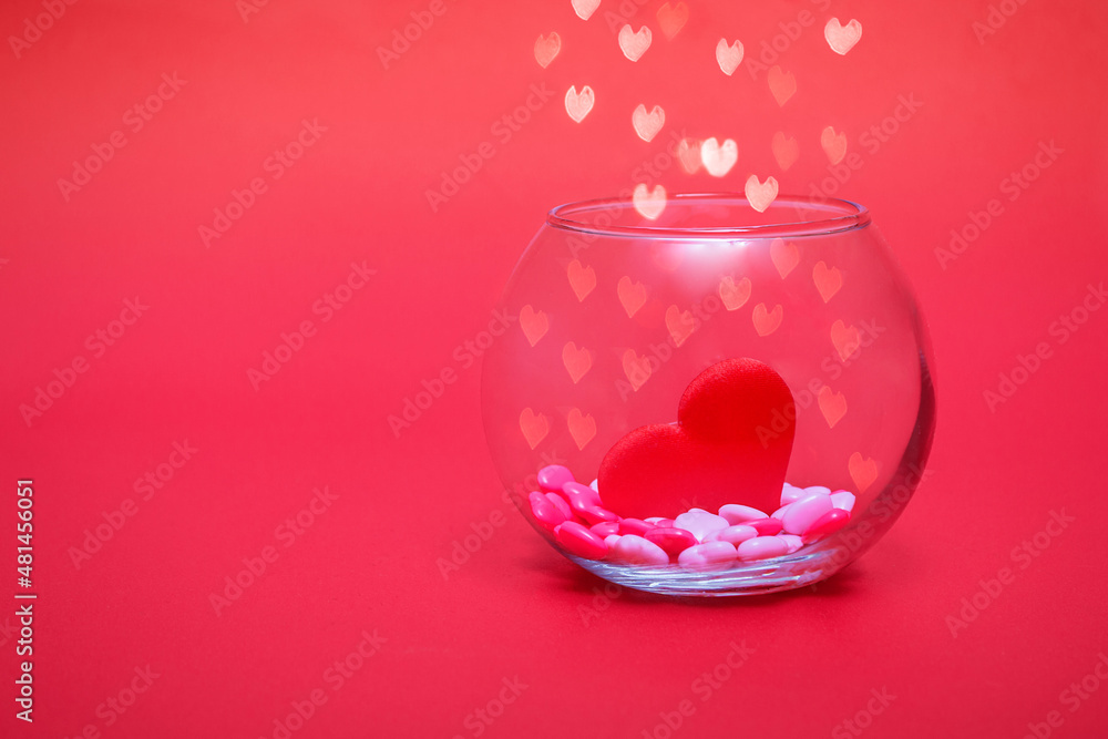 Hearts in a round transparent vase on a red bokeh background with hearts. Valentine's day or mother's day holiday background. Copy space text. Hearts in a round transparent vase on a red bokeh background with hearts. Valentine's day or mother's day holiday background. Copy space text.