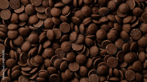 Milk chocolate chips top view. Confectionery concept