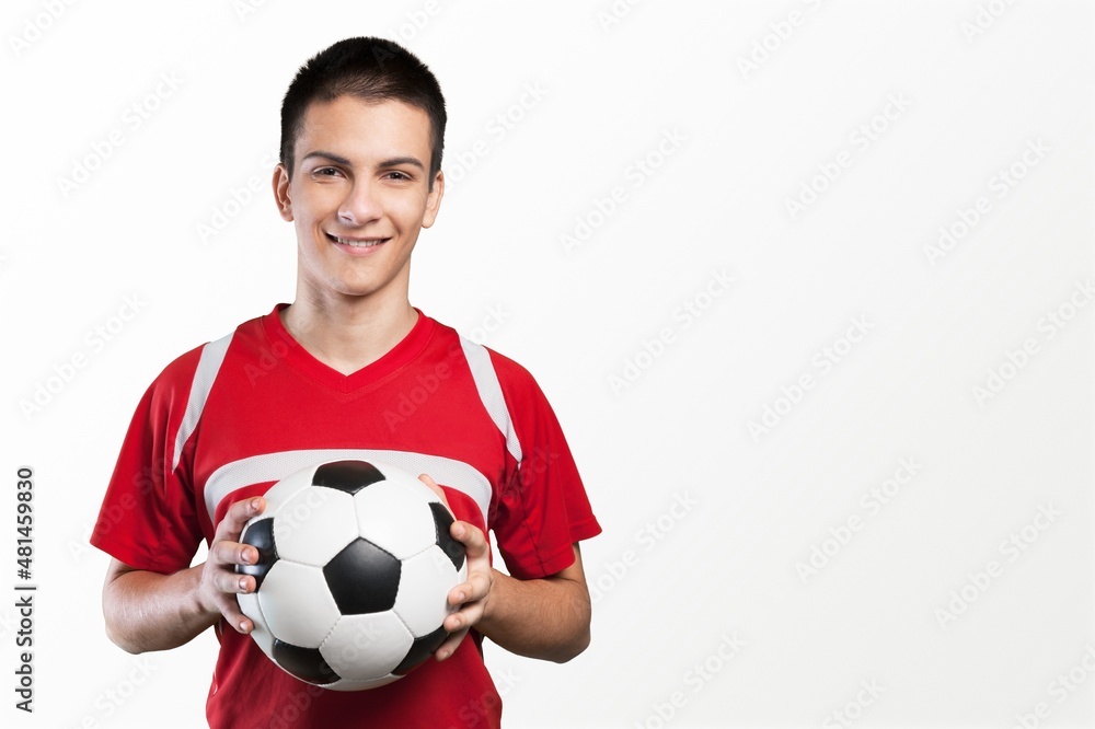 Professional football soccer player standing with ball