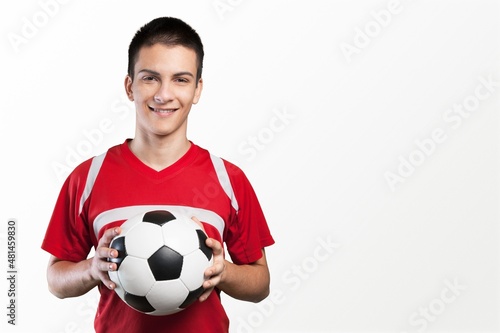 Professional football soccer player standing with ball © BillionPhotos.com