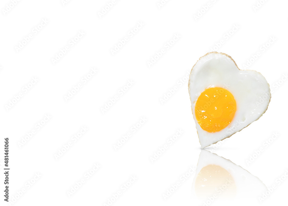 Fried egg (fried egg) in the form of a heart, isolated on a white background with reflection. A place to copy. Fried egg (fried egg) in the form of a heart, isolated on a white background with reflection. A place to copy.