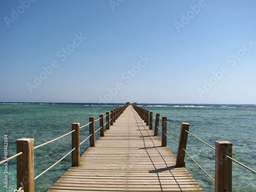 Wooden pier over a beautiful beach by the ocean