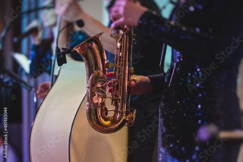 Photography Concert view of a female saxophonist, professional saxophone player with vocalis