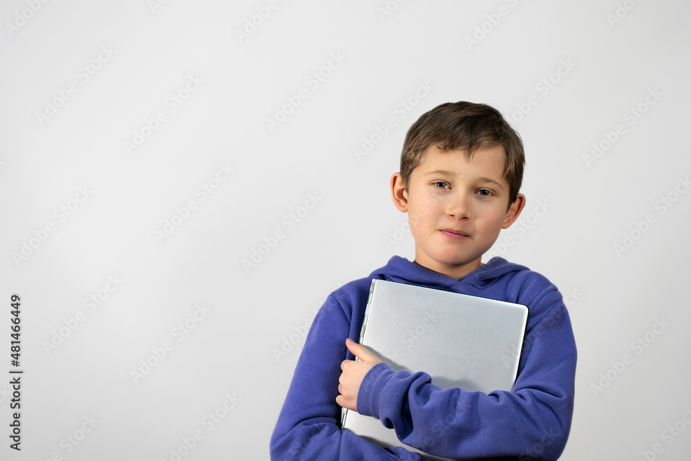Smilling boy on a white background with a laptop Smilling boy on a white background with a laptop