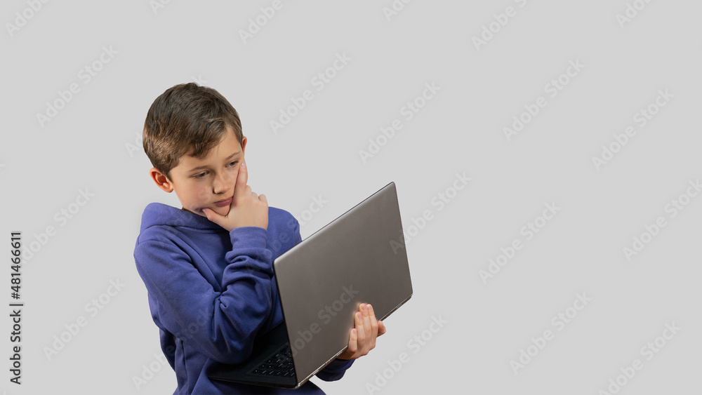 Boy on a white background with a laptop Boy on a white background with a laptop