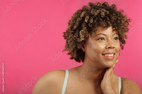 Studio shot of woman on pink background © Cultura Creative