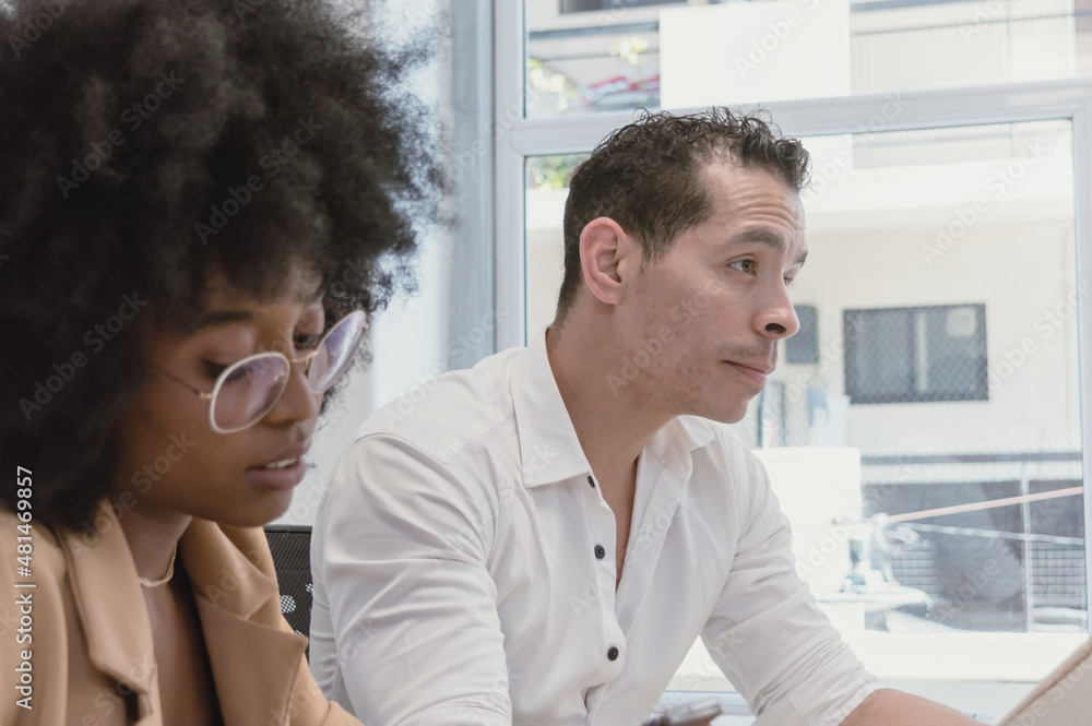 Fototapeta premium young Latino man and woman of different ethnicities meeting in a business office