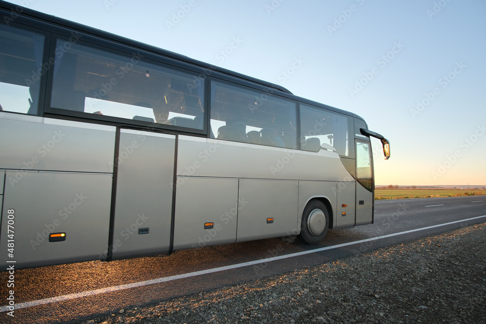 Intercity passenger bus driving on highway in evening