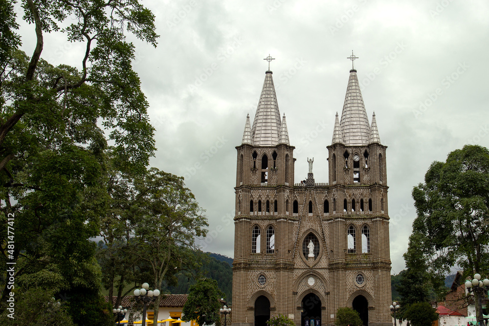 Fototapeta premium Church of a town in Colombia with colored houses