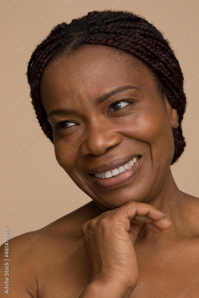 Studio portrait of smiling mature woman with braided hair Studio portrait of smiling mature woman with braided hair