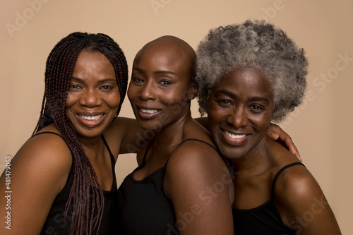Slika na platnu Studio portrait of three smiling women in black tops
